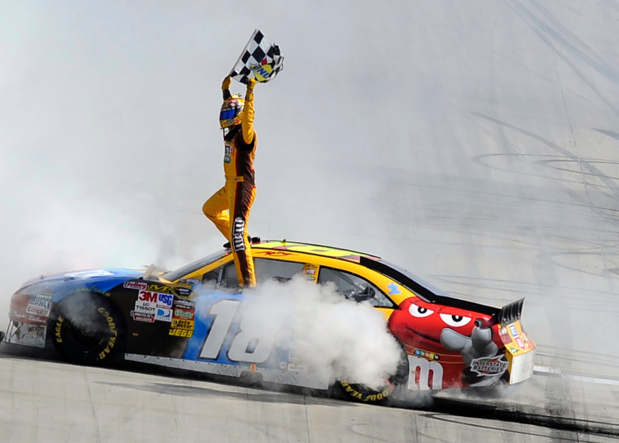 FILE – Kyle Busch celebrates his win in the NASCAR...