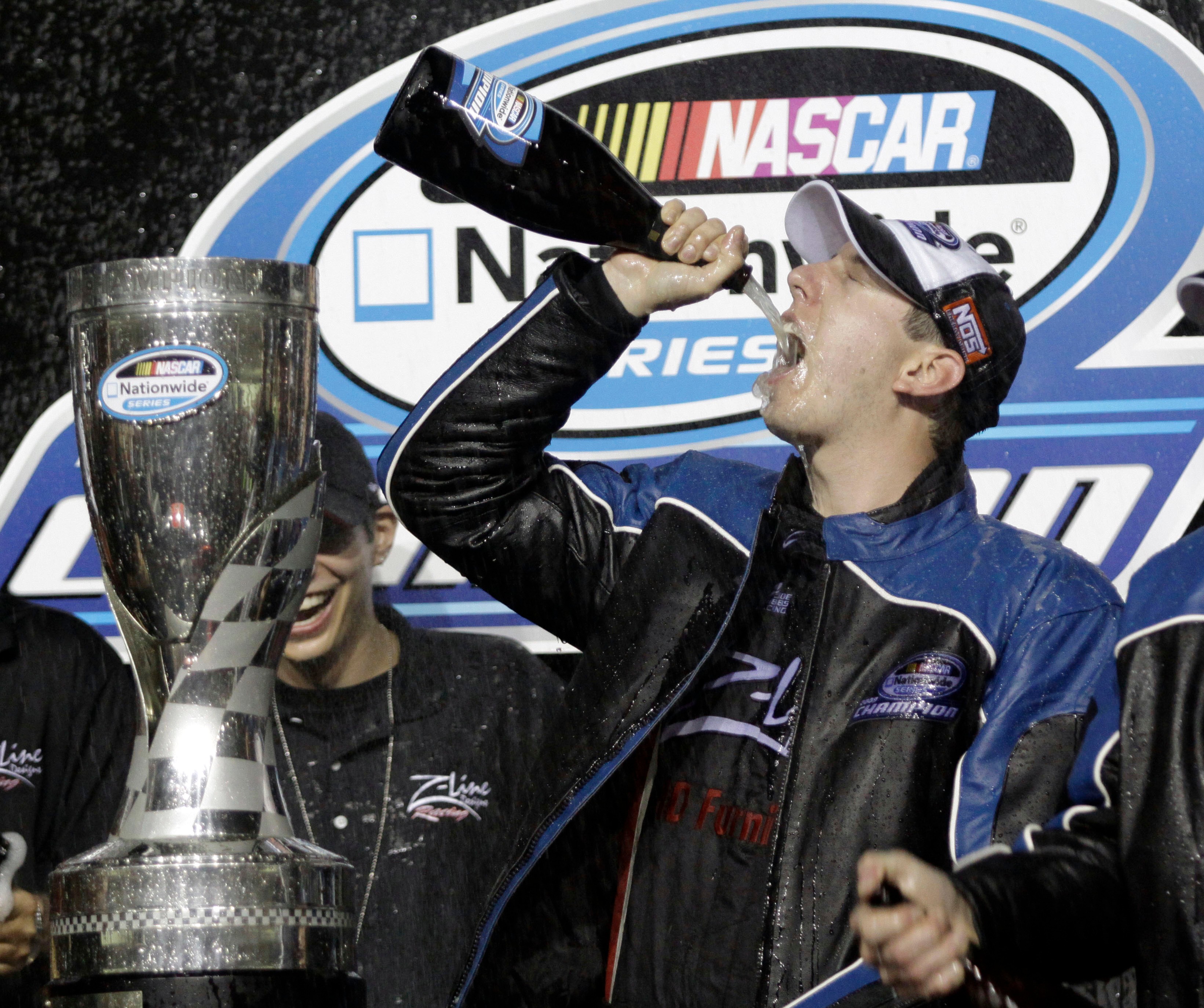 FILE – Kyle Busch drinks champagne after winning the Nationwide...
