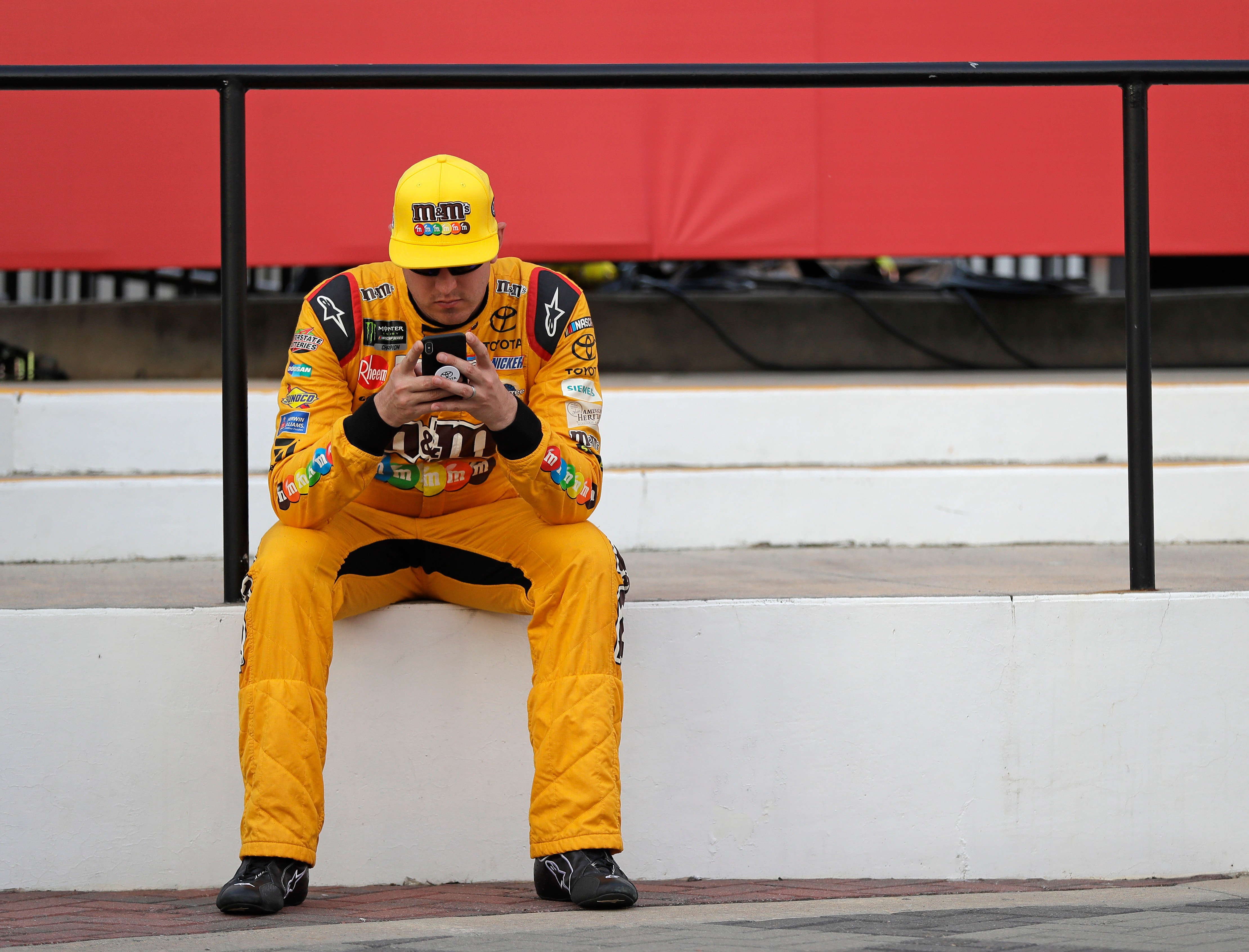 FILE – Kyle Busch waits in Victory Lane after winning...