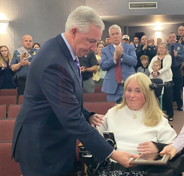 Montgomery County DA Kevin Steele presents Bernadette Gaudio with a commendation honoring the heroism of her son, Andrew. (Photo by Carl Hessler Jr. - MediaNews Group)