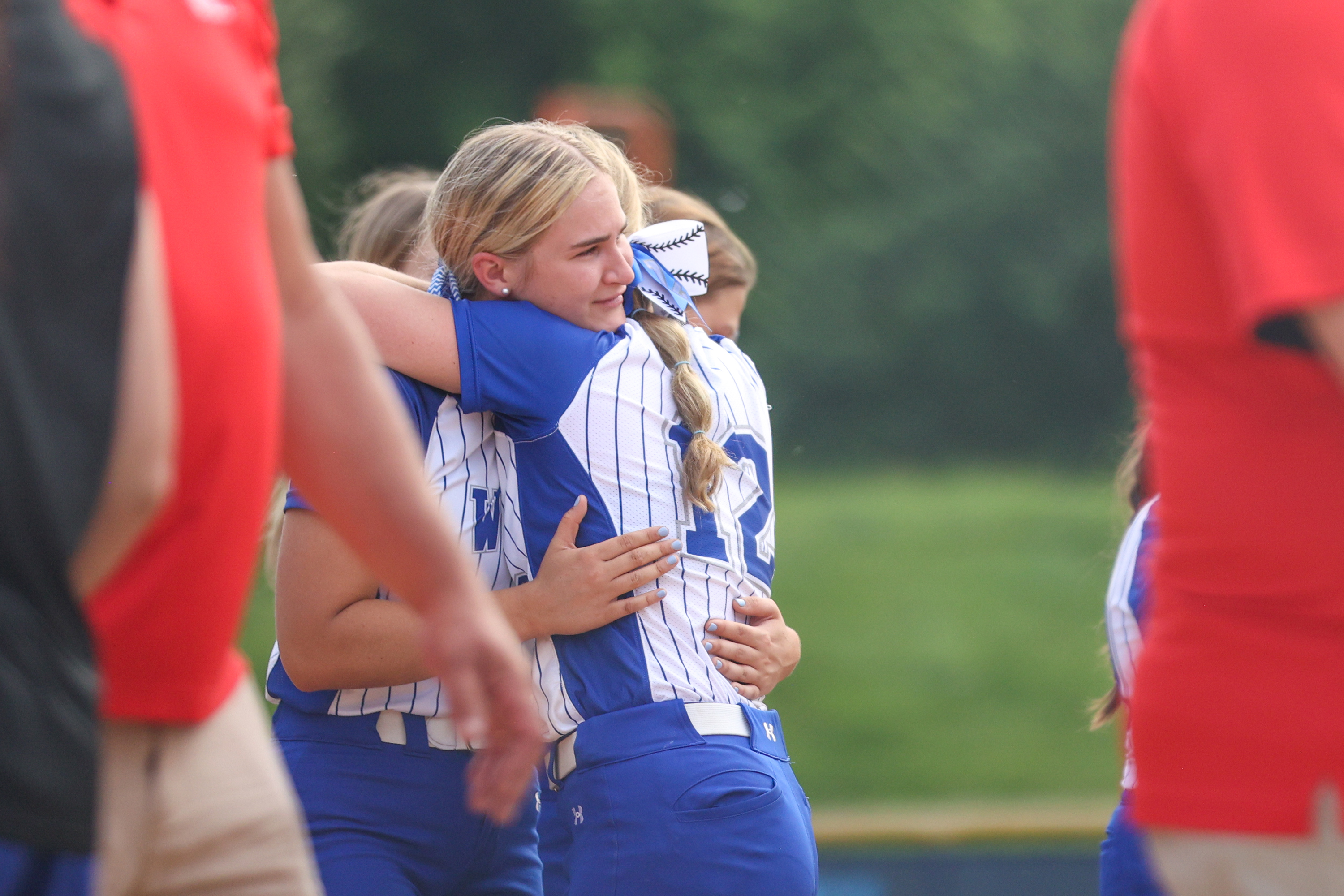 West Scranton players hug after losing to Williamsport in the...