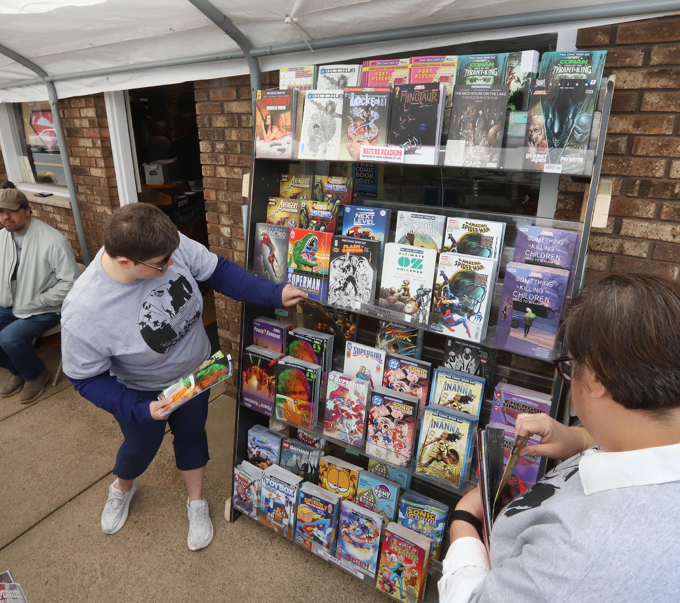 Staff member Richelle Smith moves some of the free comic...