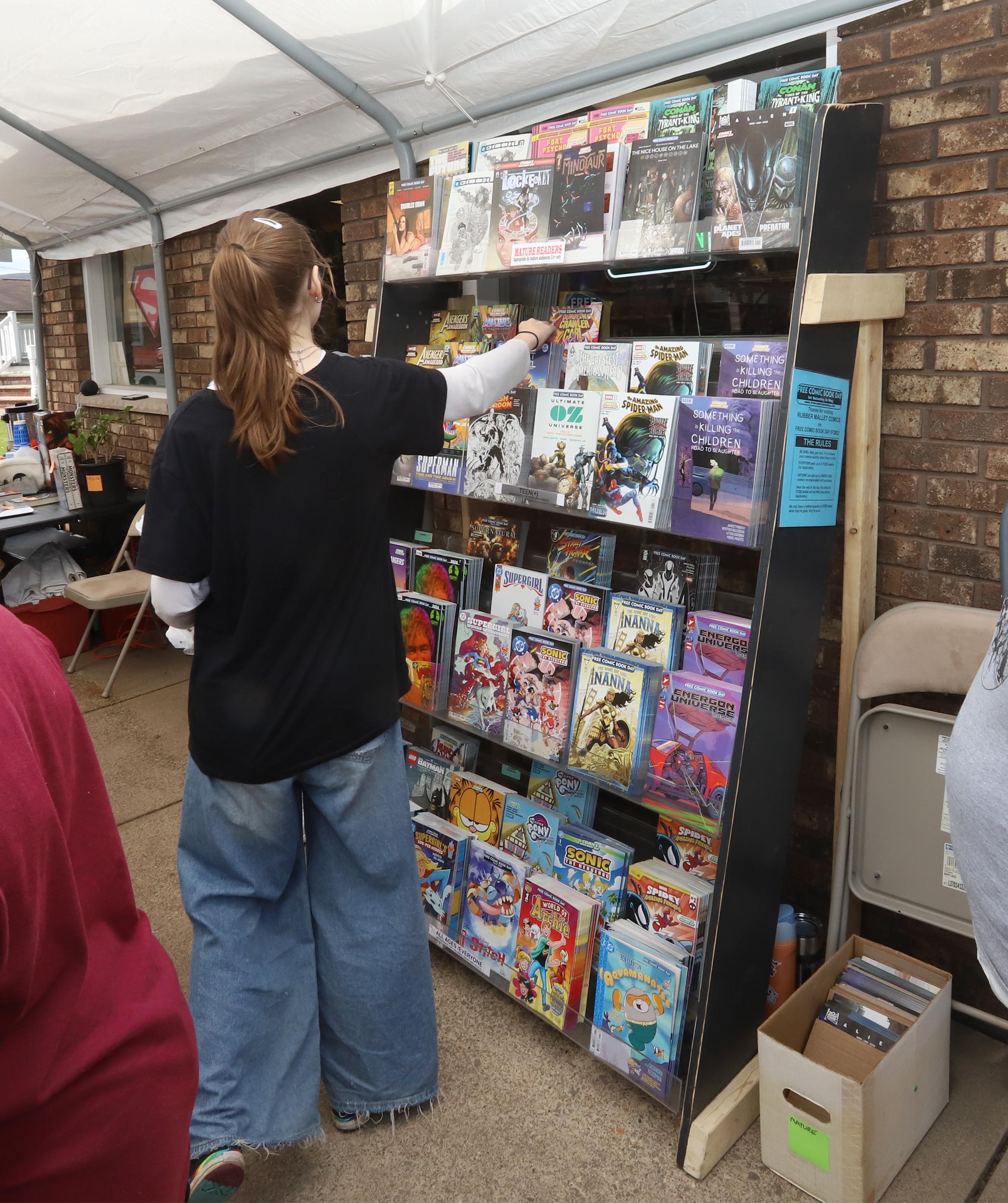A comic book fan looks over some of the free...