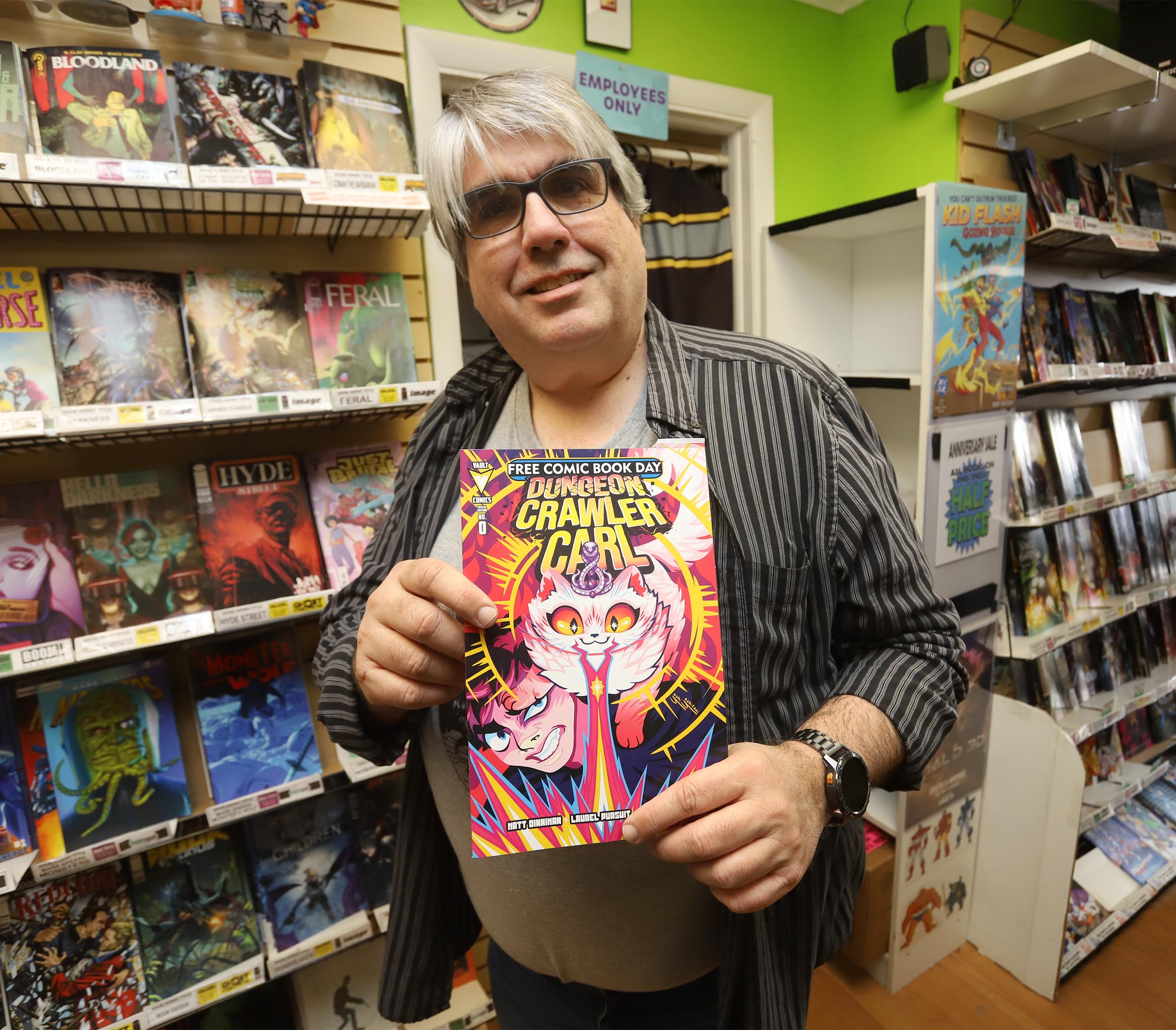 Owner Chuck Rowles holds up the very popular the Comic...