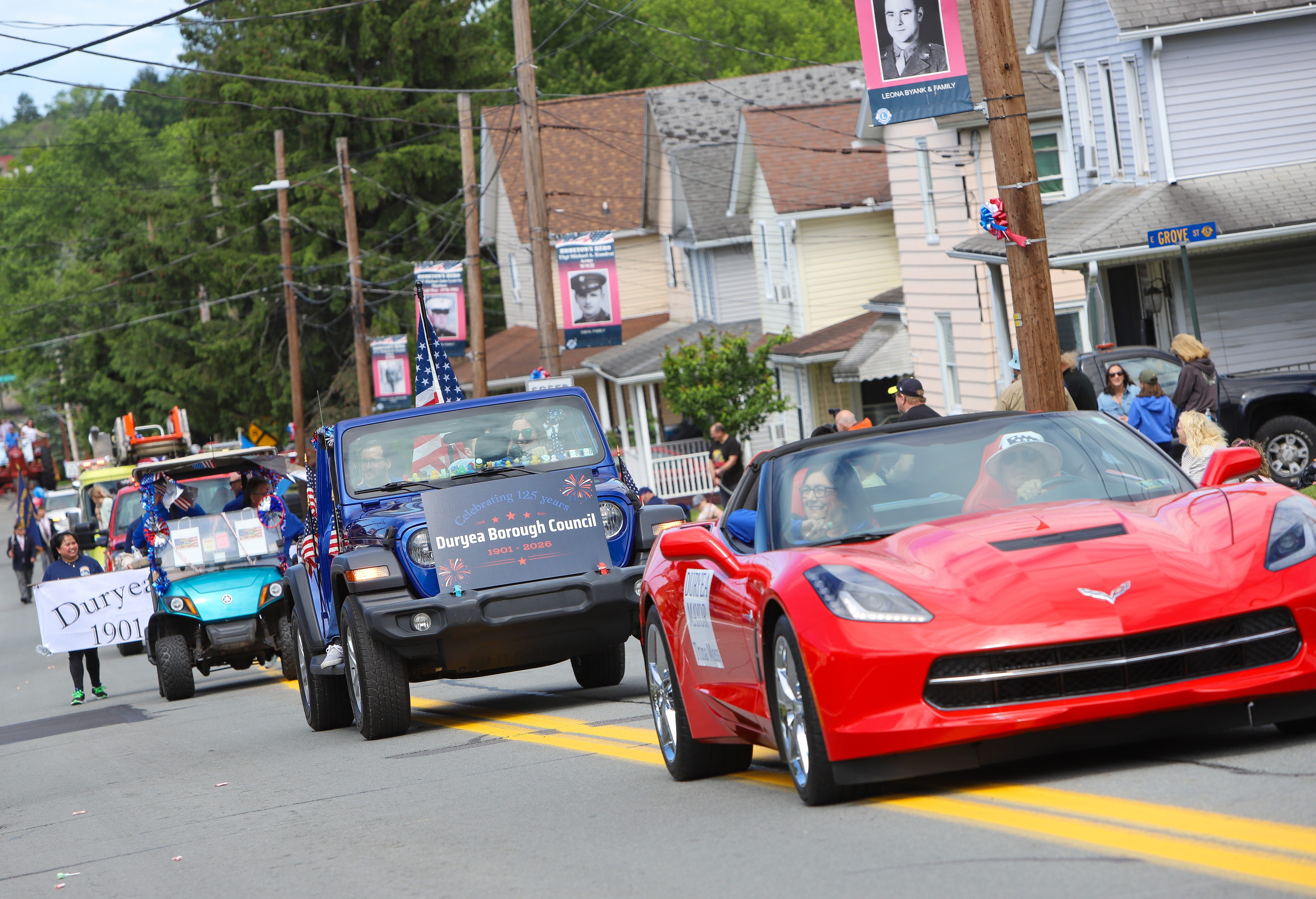 Vehicles move along the parade route during the Duryea Borough...