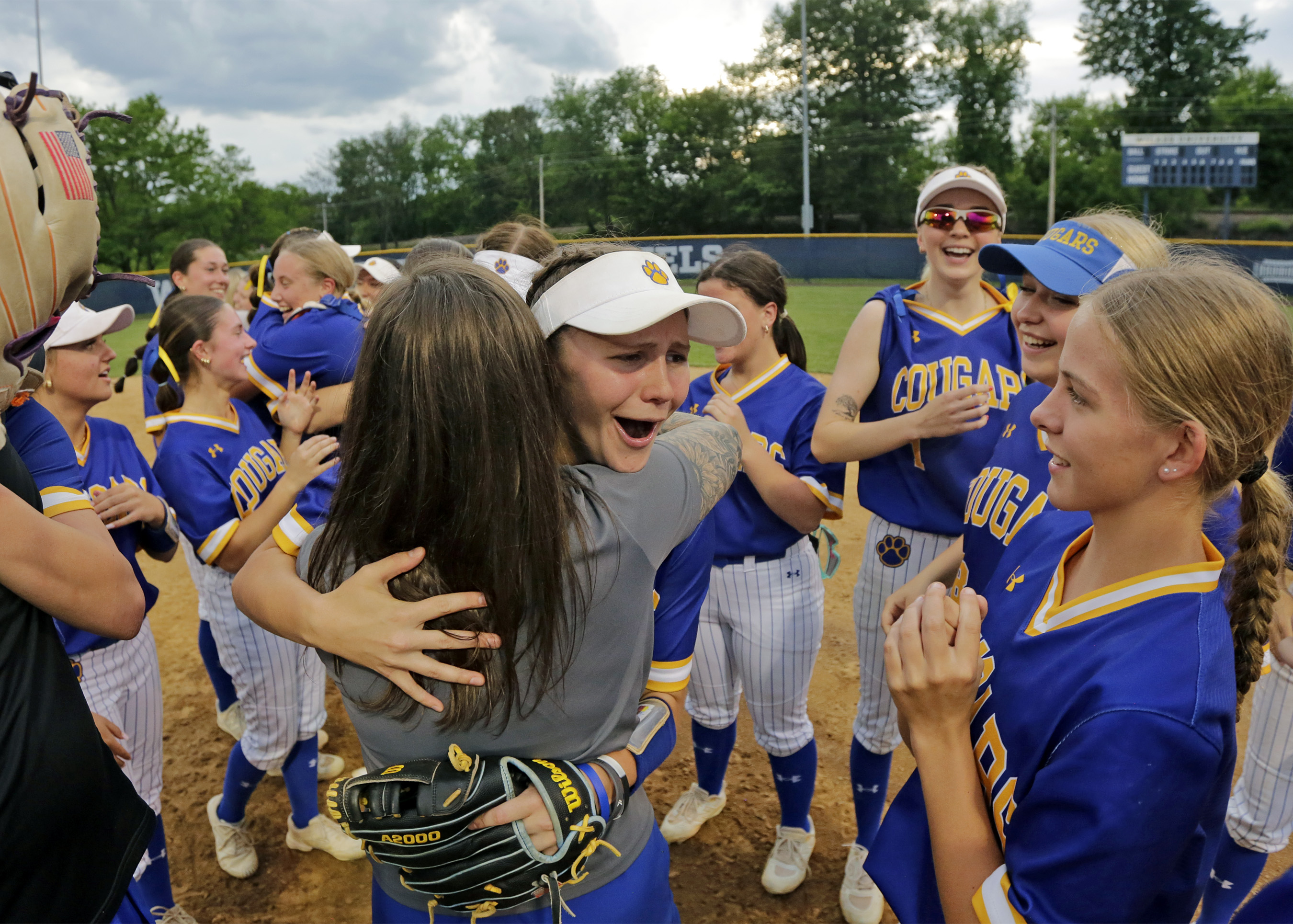 Valley View’s Cora Castellani, center, hugs her coach after the...