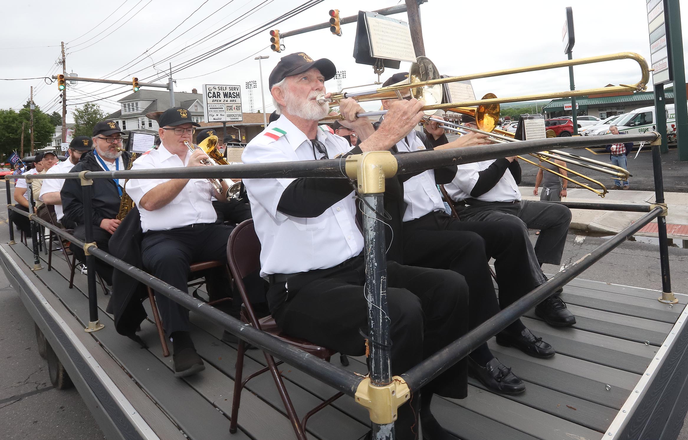 Members of the Cino Paci Band make their way along...