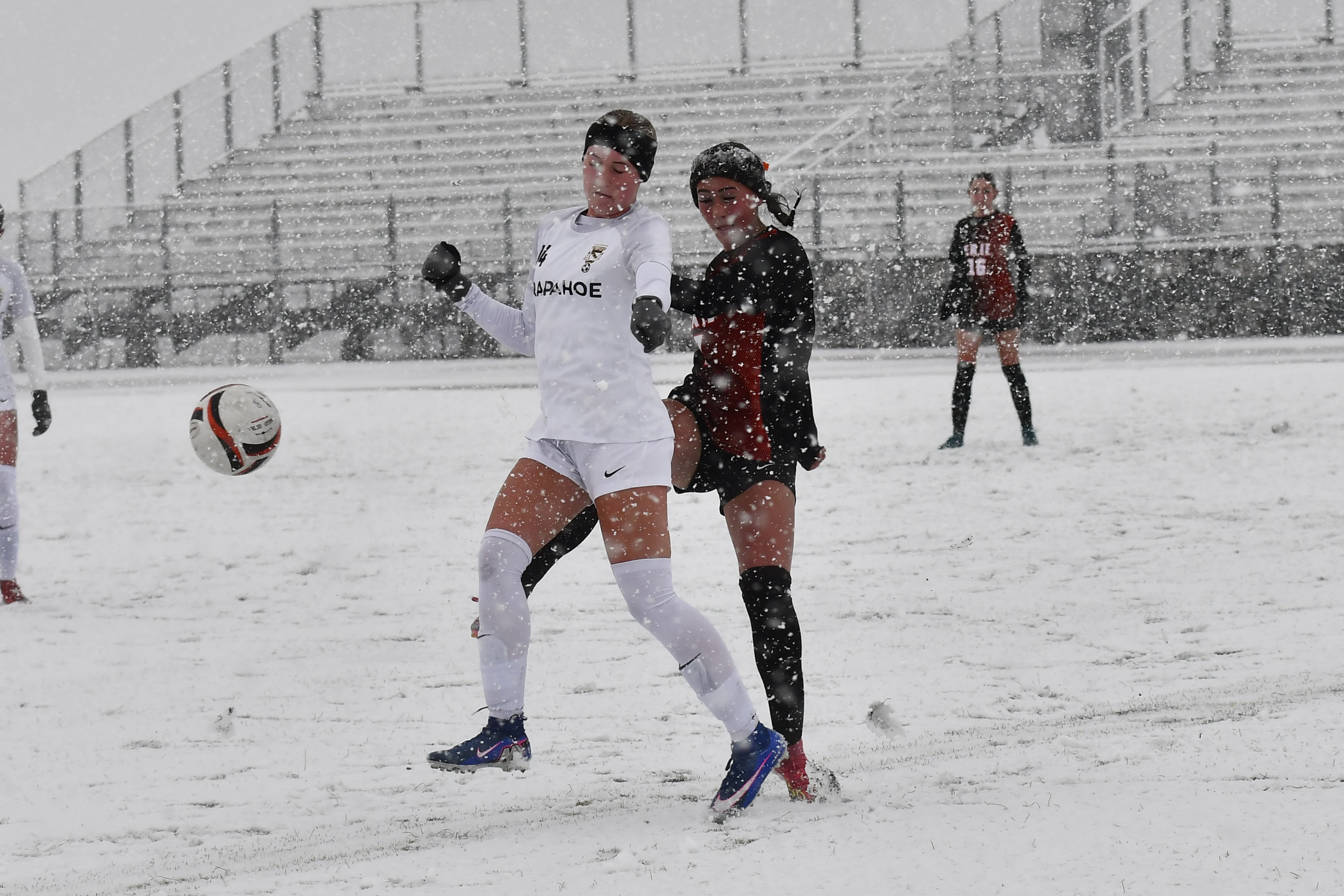 Erieâs Tayllin Maynes fights for ball control with Arapahoe's Paige...