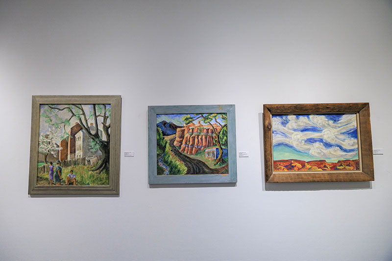 Framed landscape paintings displayed inside an art gallery at the Everhart Museum in Scranton, PA featuring colorful scenes and regional-inspired artwork.