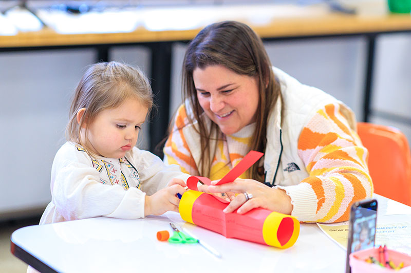 Child and adult creating a colorful craft together during a family-friendly activity at the Everhart Museum in Scranton, PA. 
