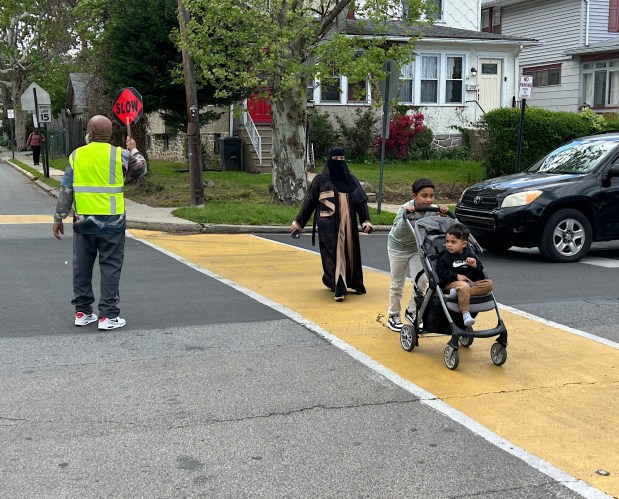 Crossing guards man key intersections are peak pedestrian times. (PETE BANNAN-DAILY TIMES)