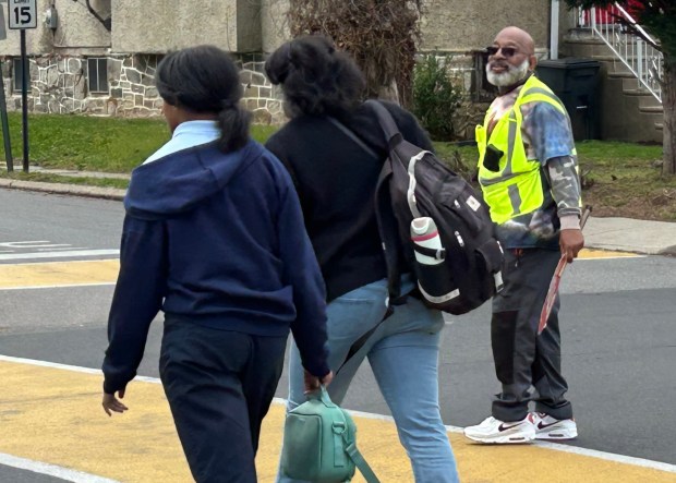 The East Lansdowne Police Department has equipped their five crossing guards, including Albert Gilliard, above, with body cameras. Gilliard works the Emerson Avenue and Penn Boulevard intersection, down the street from Vision Charter School. (PETE BANNAN-DAILY TIMES)