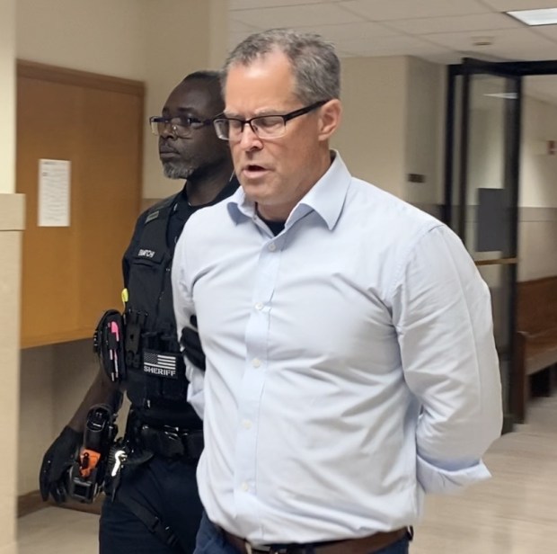 John Grzyb is escorted by a deputy sheriff from a Montgomery County courtroom with a 4 to 8 year prison sentence. (Photo by Carl Hessler Jr. - MediaNews Group)
