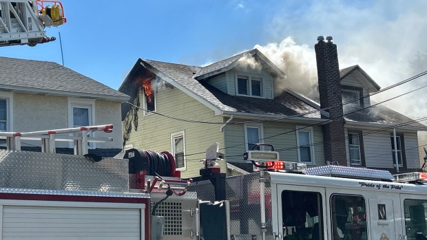 Flames leap out of the attic window. (PETE BANNAN-DAILY TIMES)