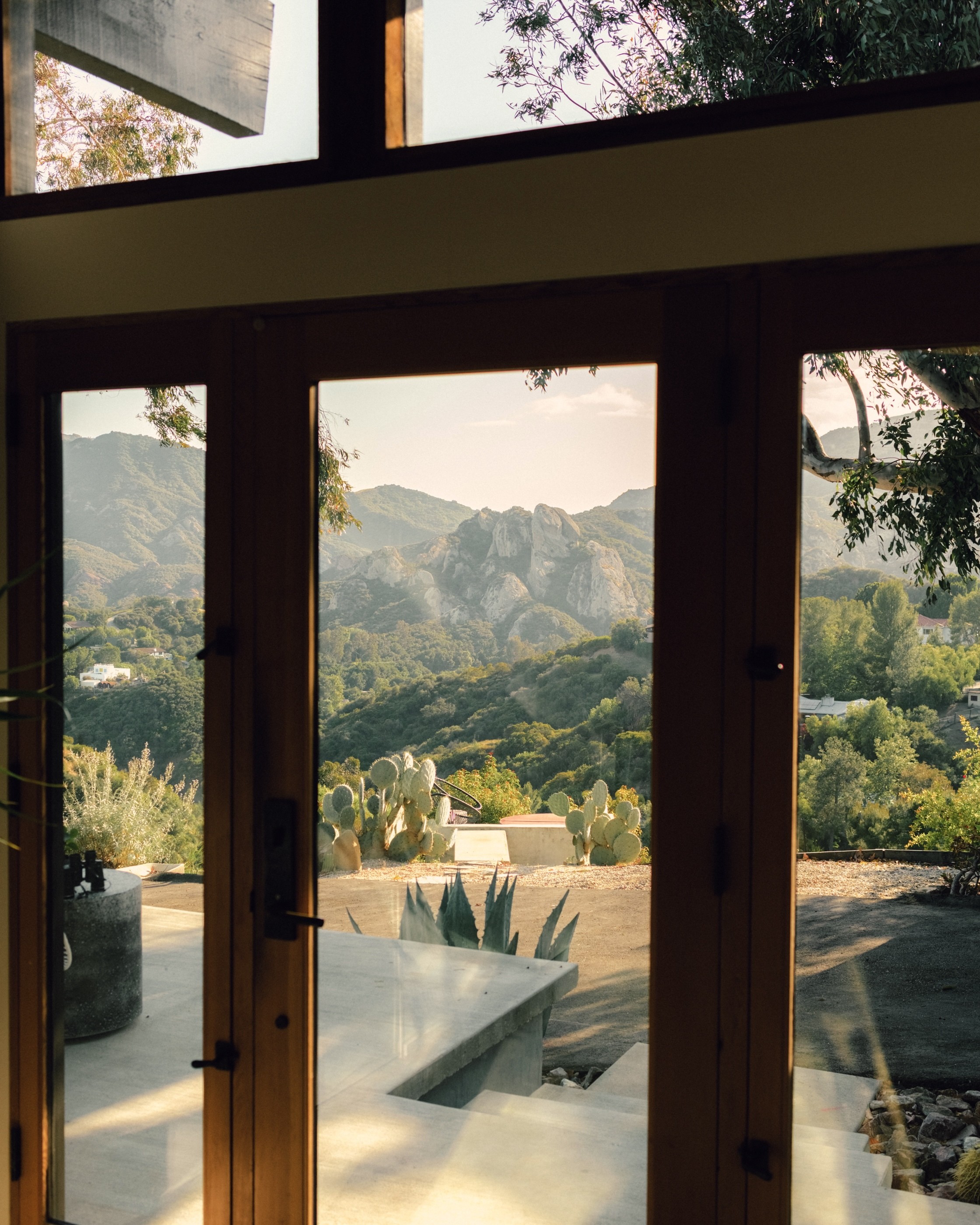Walls of glass capture views of the chaparral-covered Santa Monica...