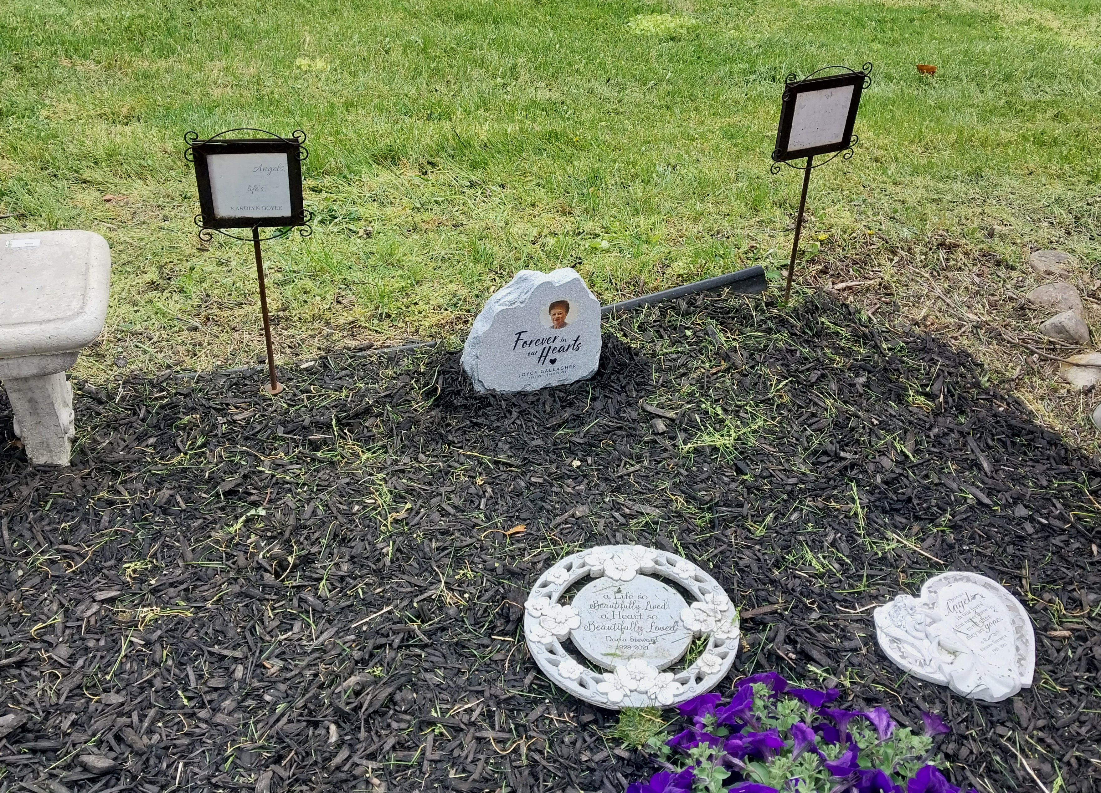 A commemorative garden stone honors the recent passing of beloved...