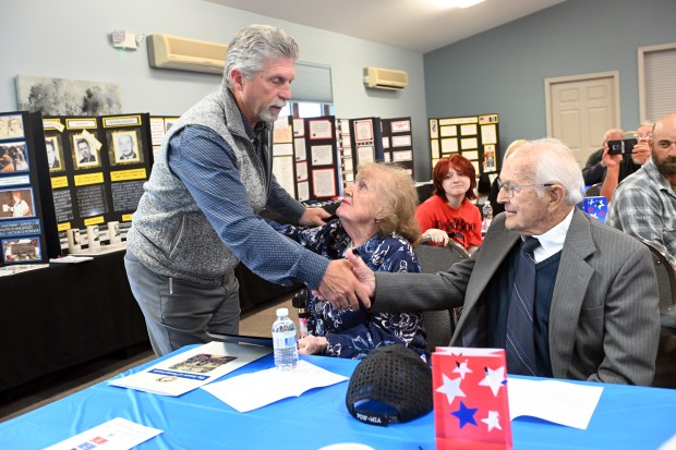 State Rep. David Maloney Sr. greets Janet Angstadt Clauser and her husband Curtis during a memorial dedication service on Saturday, May 9, 2026, at Friedens UCC in Oley for Lt. Col. Ralph H. Angstadt, who is Missing in Action in Vietnam. (BILL UHRICH/READING EAGLE)
