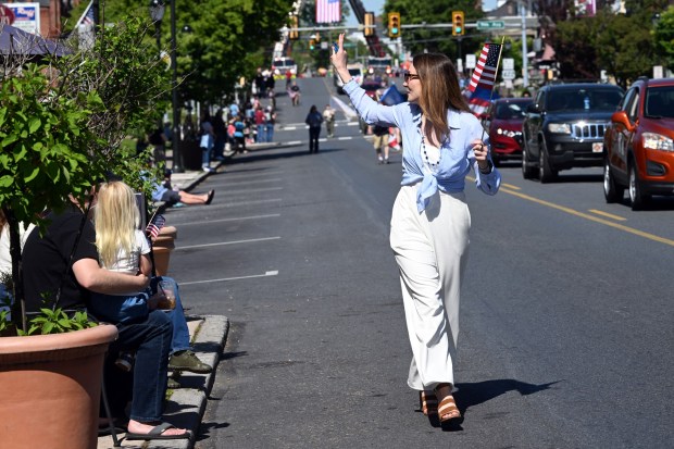 West Reading Mayor Samantha Kaag distributes flags during the Armed Forces Day Parade on Penn Avenue in West Reading on Saturday, May 16, 2026.  (BILL UHRICH/READING EAGLE)