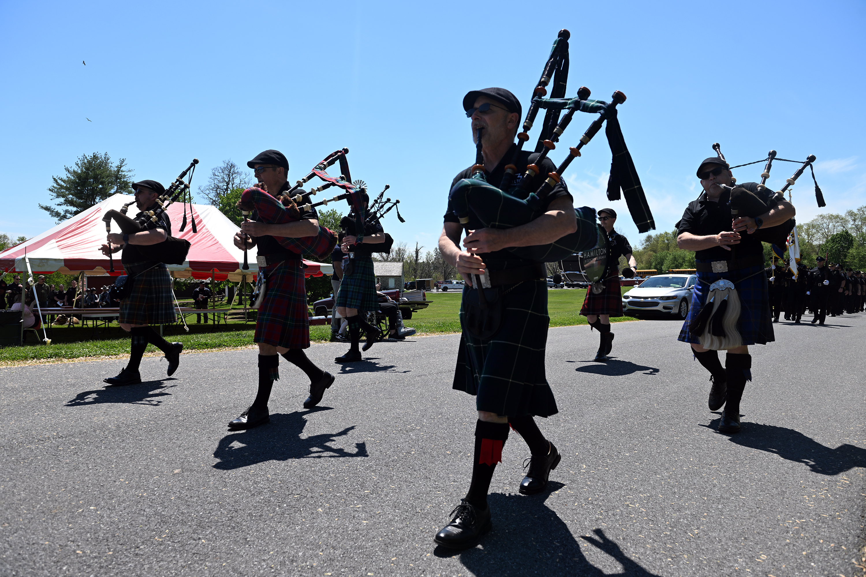The Hamilton Pipe and Drum Band leads the honor guard...