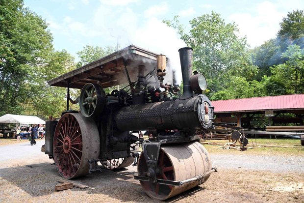 The 1918 Case 10-ton, steam-powered roller owned by Jarrad Jacobs of Bern Township blows off some steam as its whistle sounds during the Hay Creek Festival at the Joanna Furnace Historic Site in Robeson Township. (BILL UHRICH/READING EAGLE)