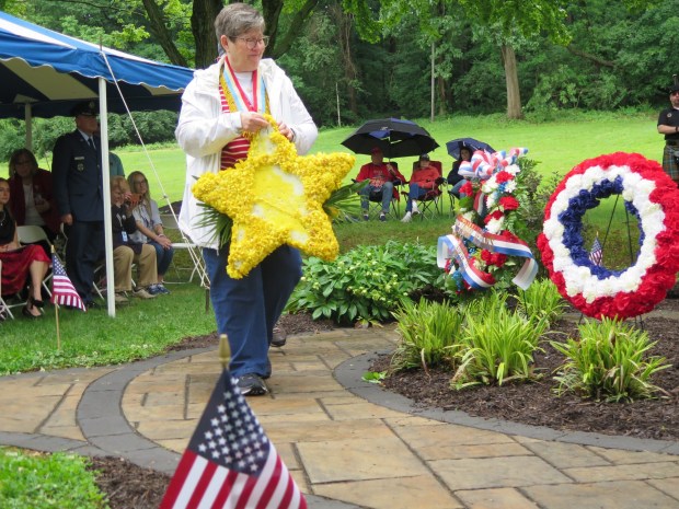 Joyce Crider lays a wreath in honor of her late daughter, Erin, during a Memorial Day ceremony on Monday in Wyomissing Hills. (KAREN SHUEY - READING EAGLE)