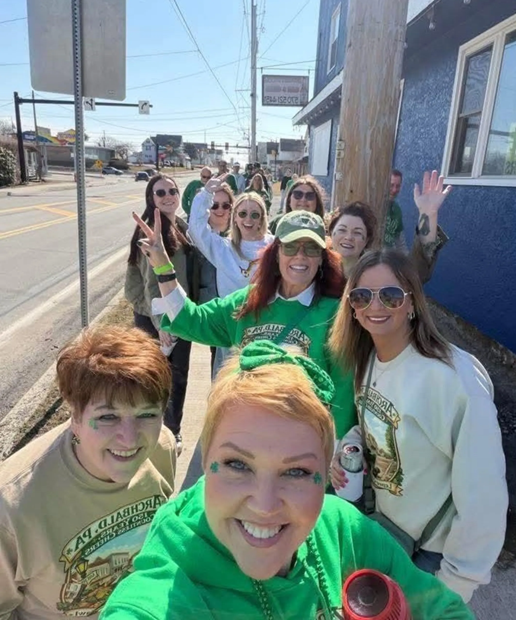 Participants of the Lepre-Con Pub Crawl walk the streets of...