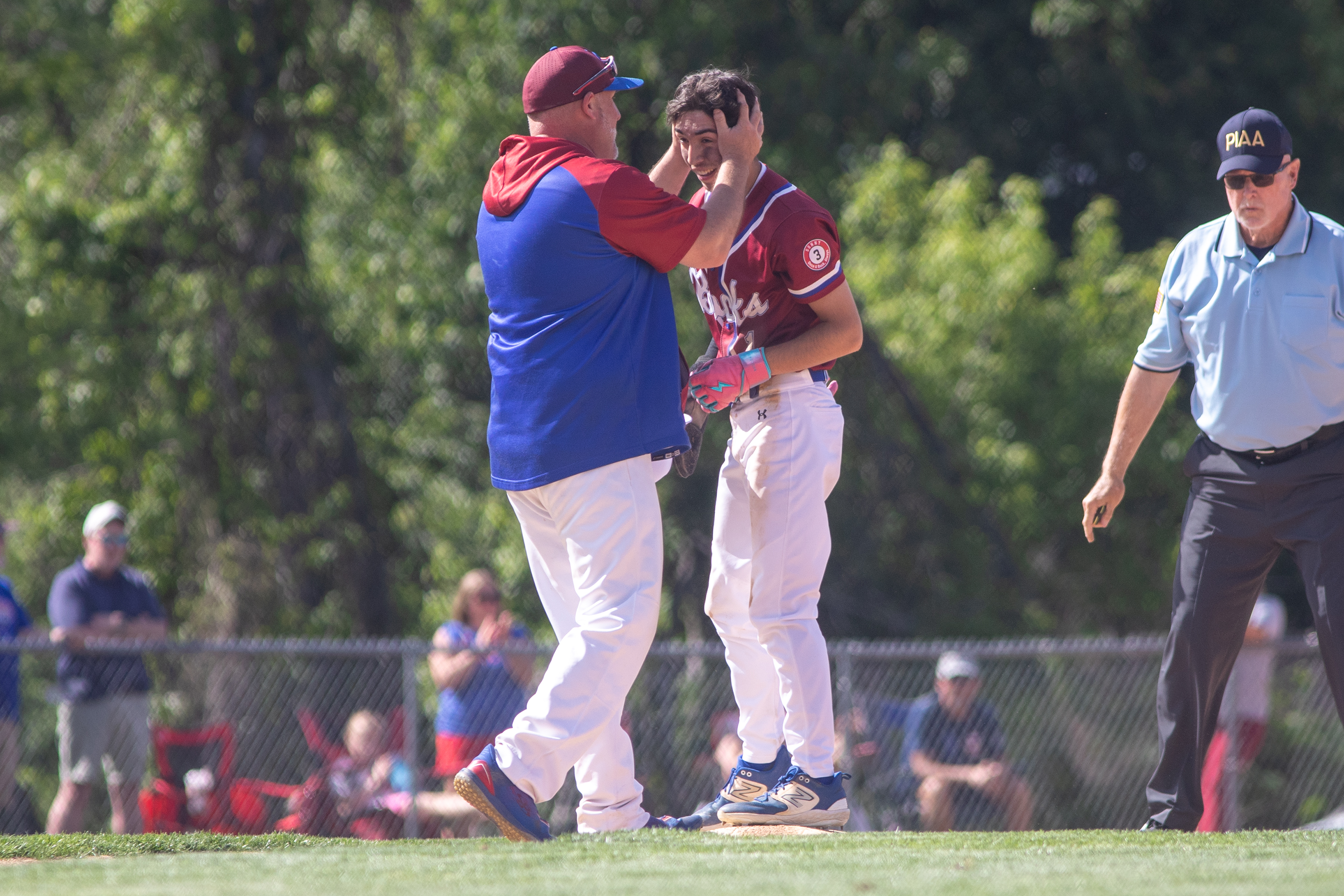Dunmore head coach Sid Hallinan embraces Jaedyn Kura on third...