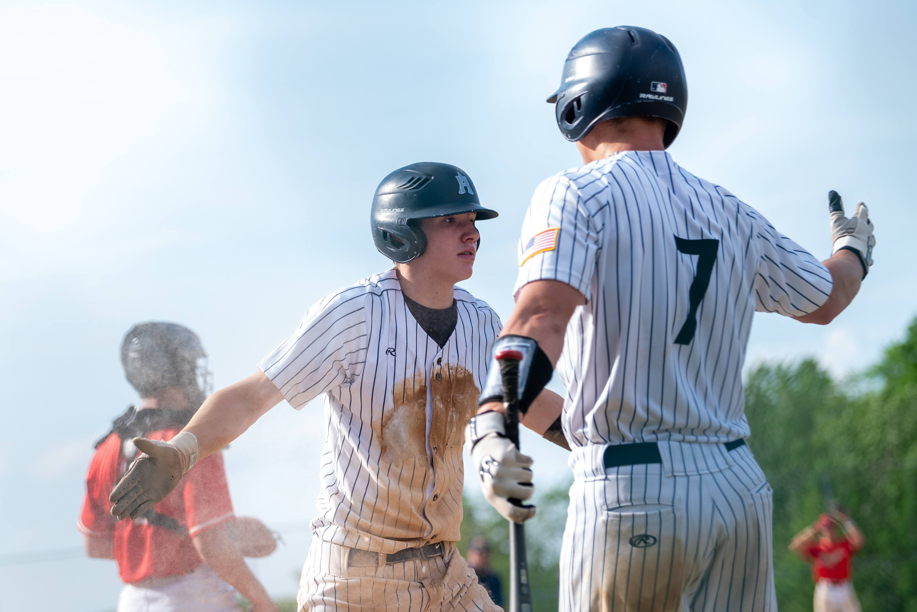 Abington Heights’ Luke Dougherty high fives his teammate Nick Bradley...