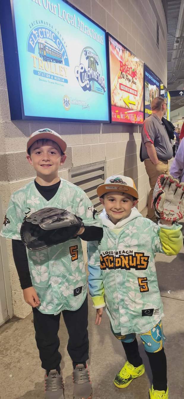 Kaesen Wagner, 9, and Roman Wagner, 6, sport their baseball gloves and Coconut jerseys Friday before Banana Ball at PNC Field on May 22, 2026. (GERI GIBBONS/STAFF PHOTO)