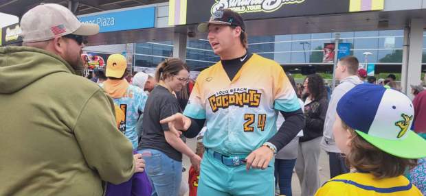 Coconut team member Andy Archer greets those attending the Banana Ball game on on Friday, May 22, 2026. (GERI GIBBONS/STAFF PHOTO)