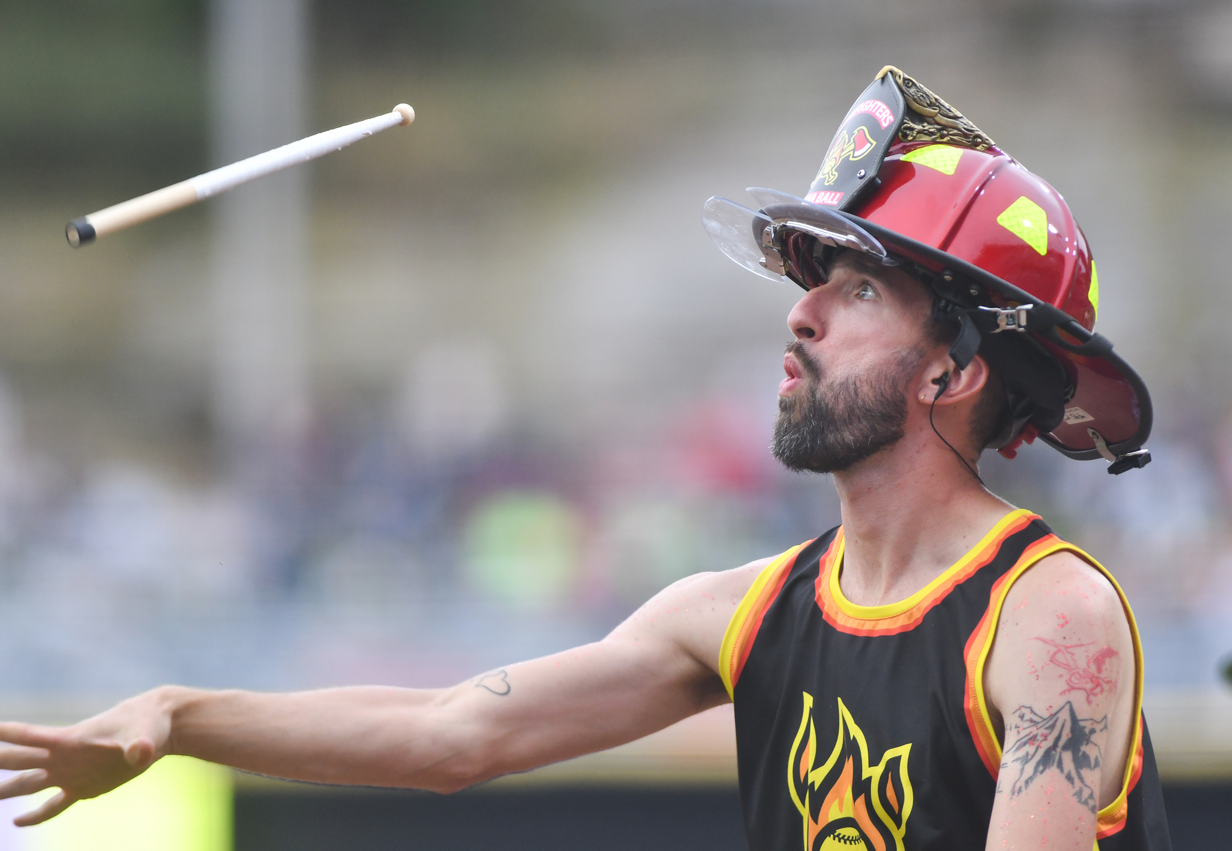 A member of The Firefighters’ drum line ‘The Fireline’ throws...