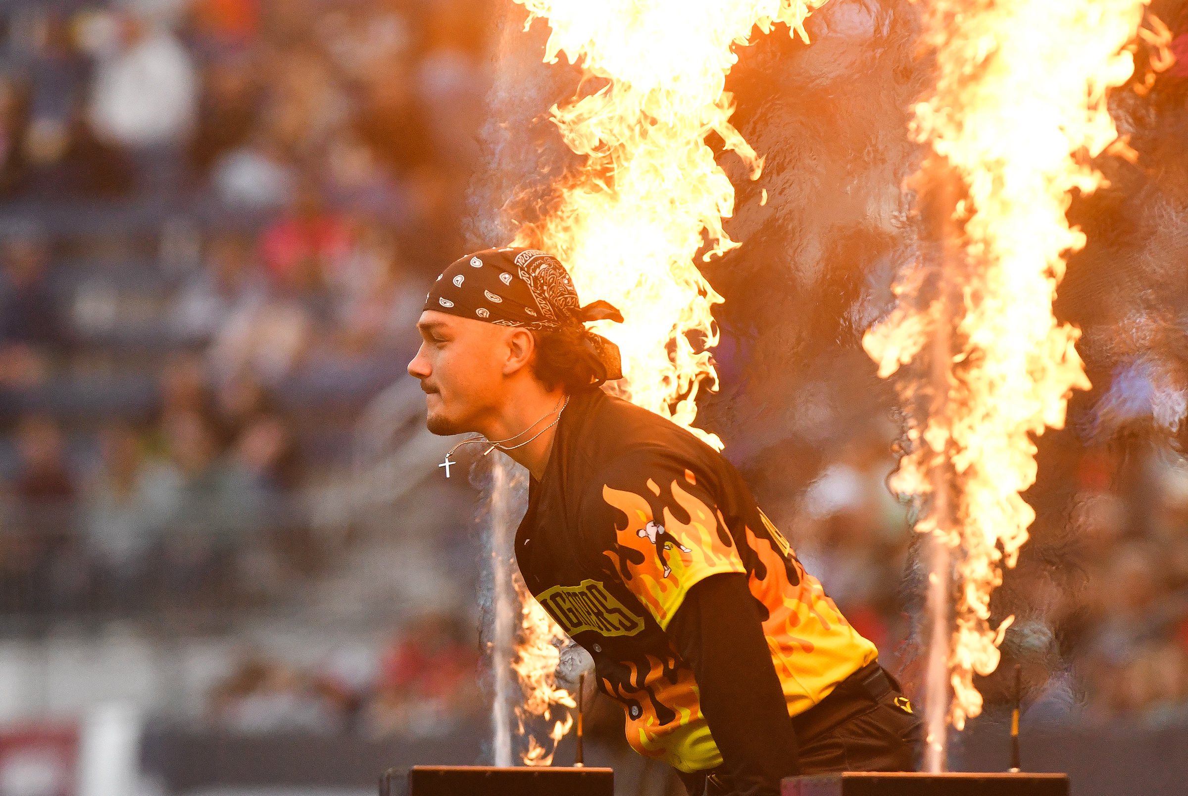 The Firefighters’ Mason Maxwell runs onto the field to start...
