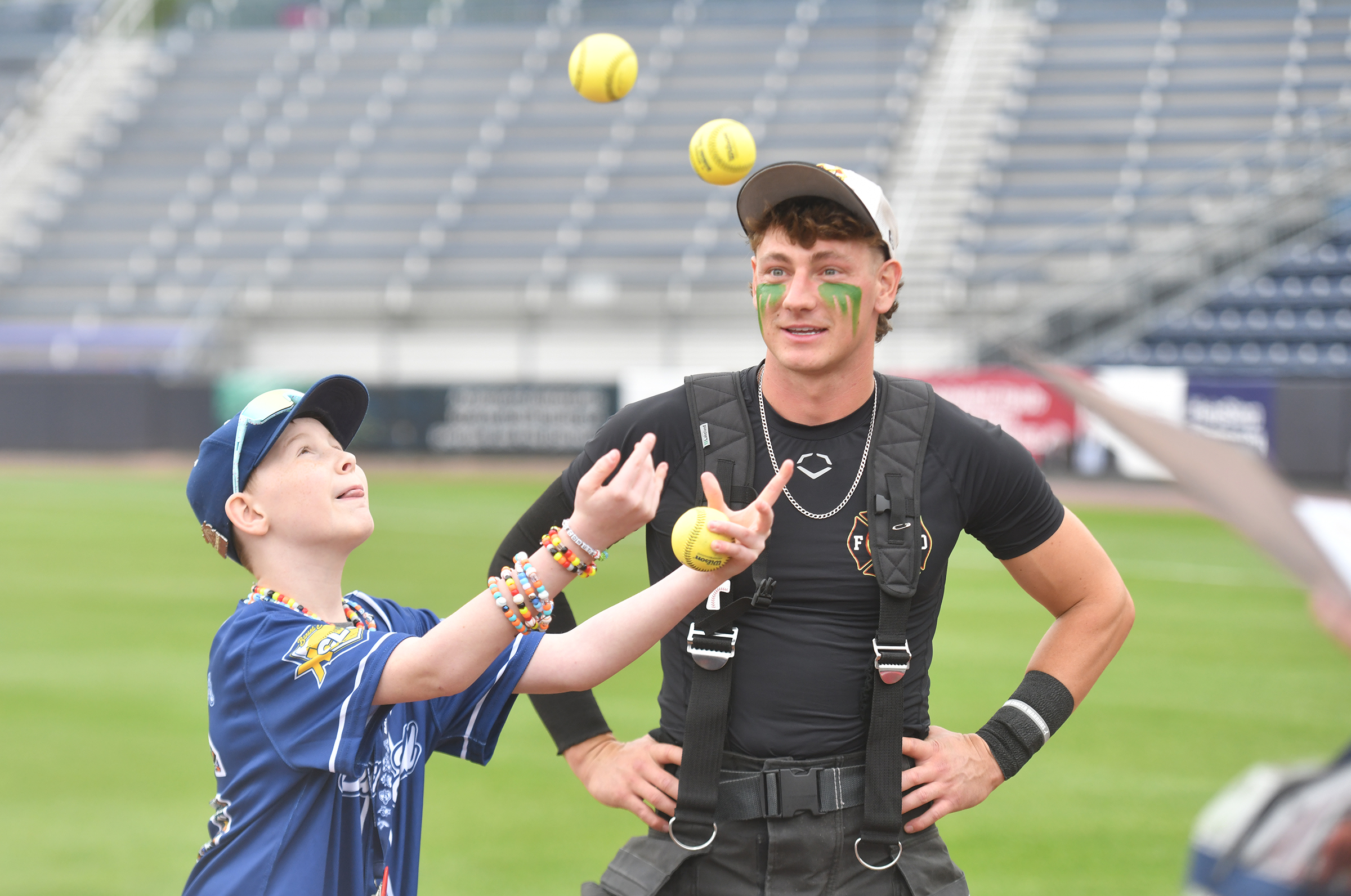 Shawn Eppley, of Johnstown, juggles baseballs as The Firefighters player...