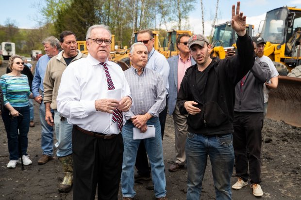 Lackawanna County Judge Thomas J. Munley, left, listens on May 2, 2019 as Scrap Enterprises owner Walter Stocki Jr. speaks during a tour of what the court considers an illegal junkyard off Keyser Avenue in Old Forge. (TIMES-TRIBUNE / FILE PHOTO)
