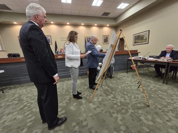 Attorney Michael Mey, left, looks on as Dickson City Solicitor Bill Jones instructs subject matter witness Jennifer Leonard to draw data center sites on a map during a zoning hearing Wednesday, April 29, 2026, at the Dickson City Borough Building. (FRANK WILKES LESNEFSKY / STAFF PHOTO)