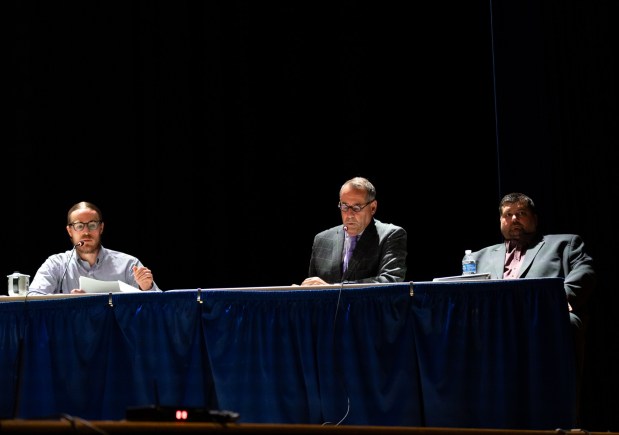 (Left to right) Essential Energy LLC traffic engineer Ian Preston of KCI Technologies, Attorney Frank Hoegen and Kriger Construction Inc. Vice President David Stiles attend a conditional use hearing in the Valley View High School auditorium in Archbald as council considers their 400-megawatt natural gas power plant on Thursday, May 21, 2026. (FRANK WILKES LESNEFSKY / STAFF PHOTO)