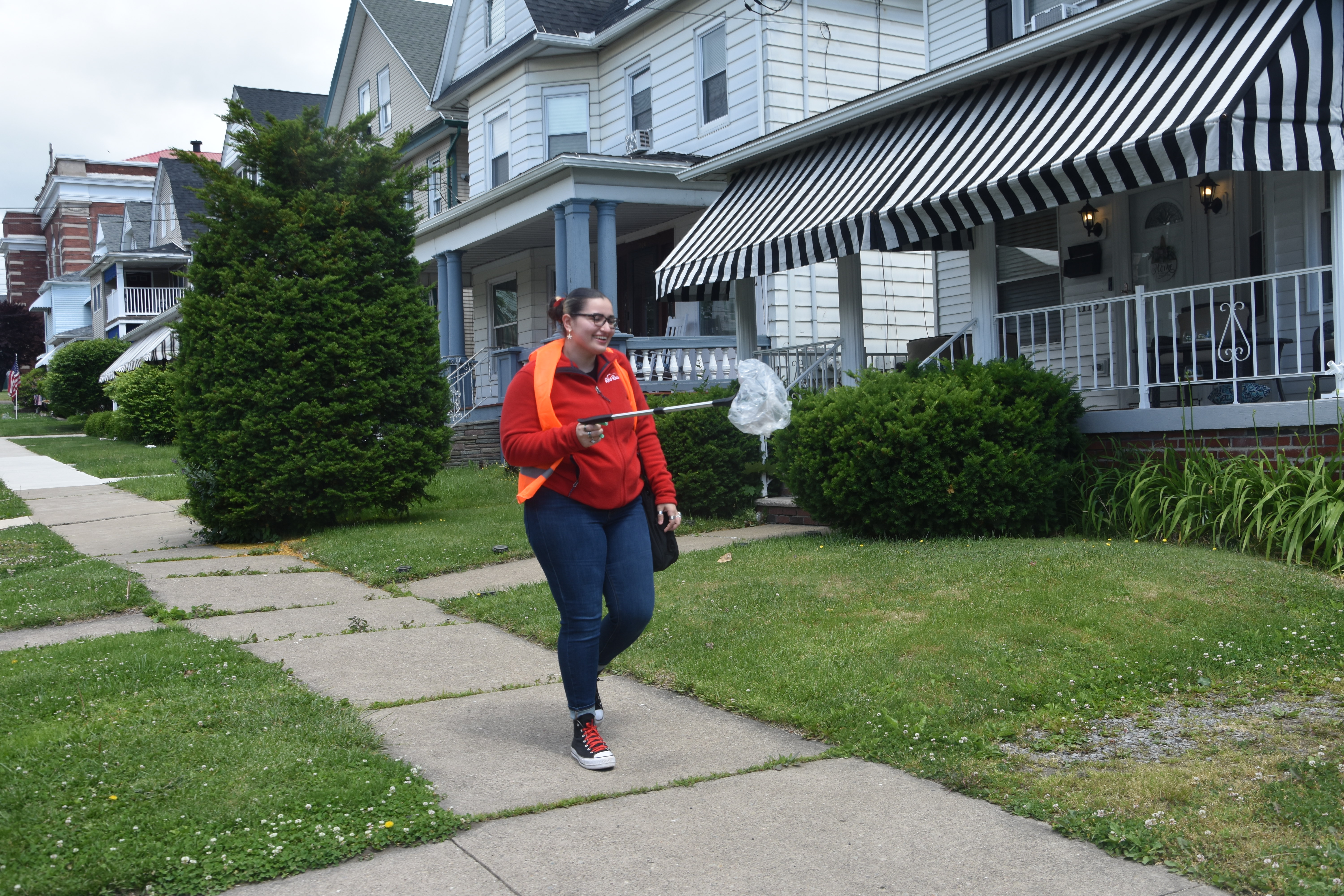 West Scranton resident Skylar Marcen picks up a piece of...