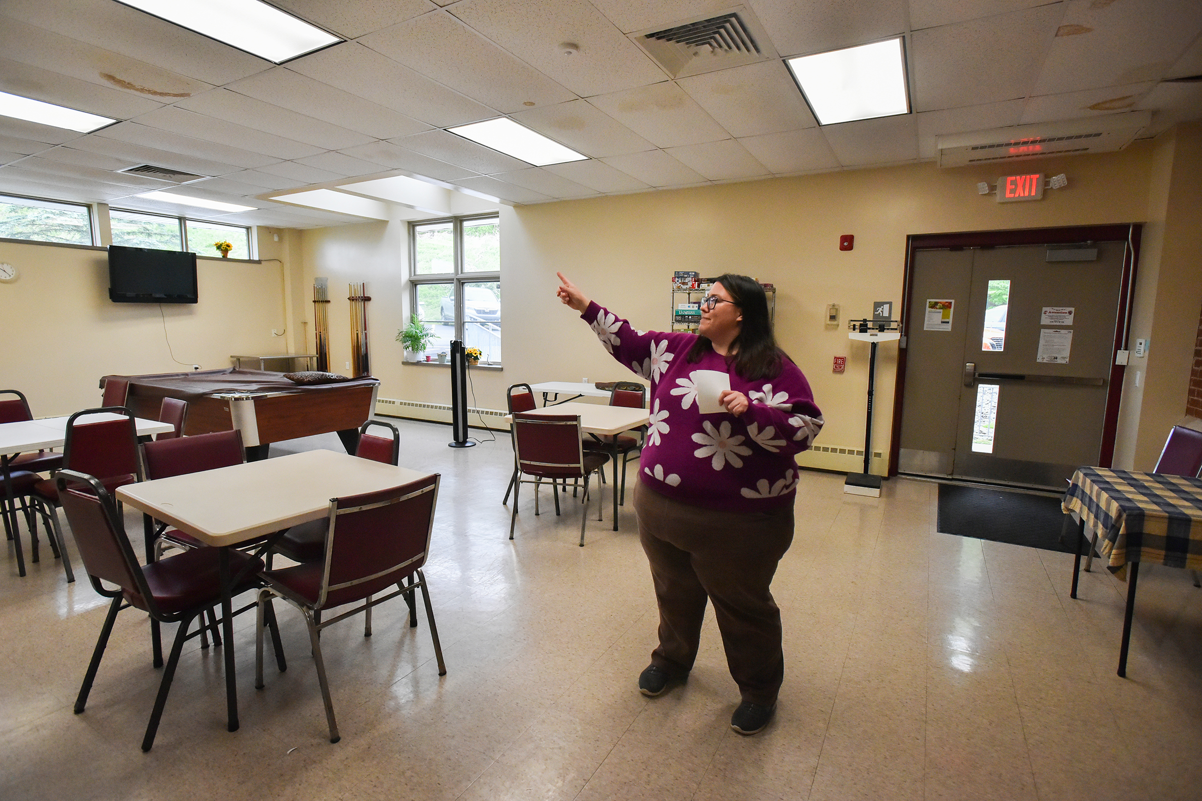 United Neighborhood Centers Senior Center Program Coordinator Amanda Buchko points...