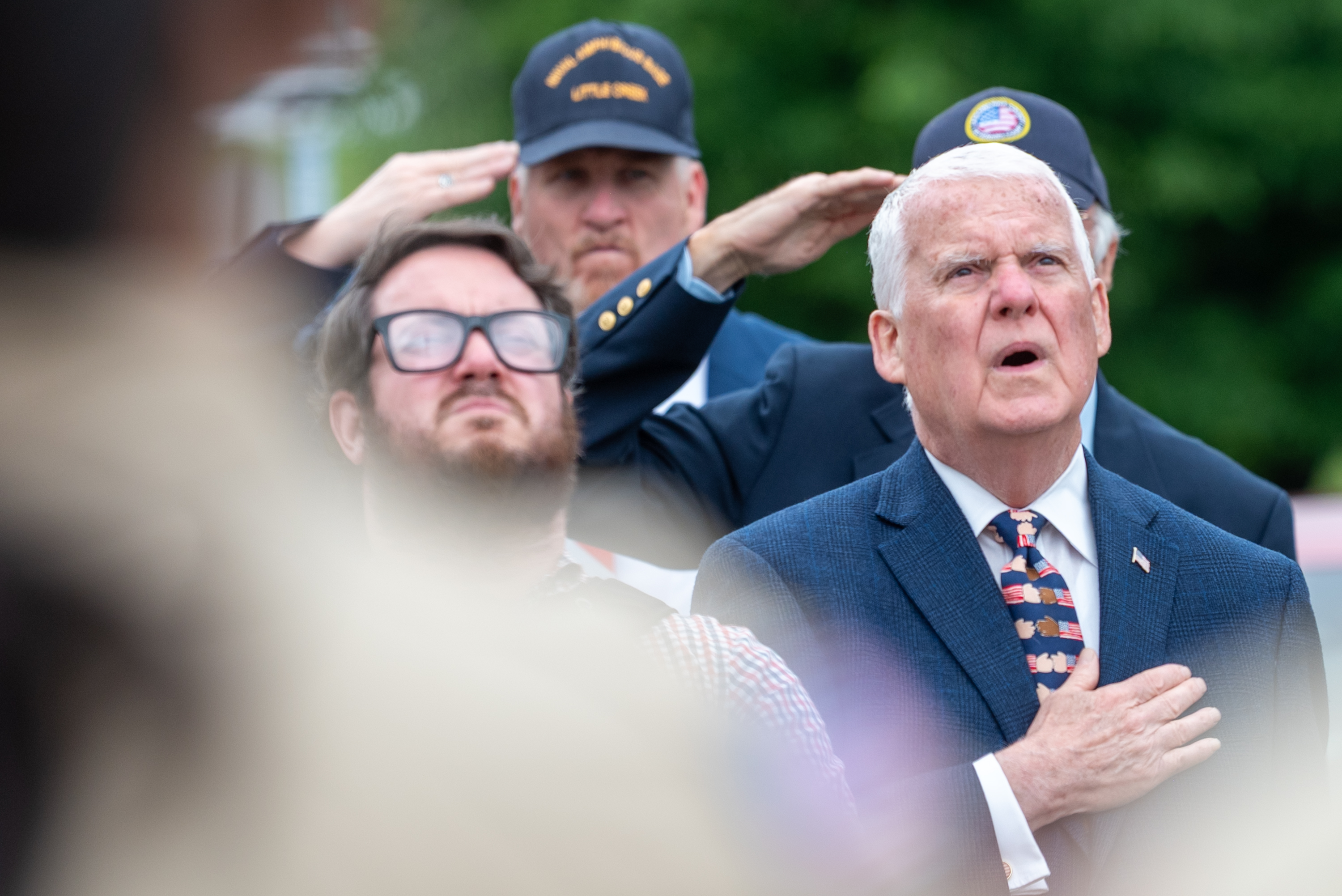 Lackawanna County Commissioner Thom Welby sings along to the National...