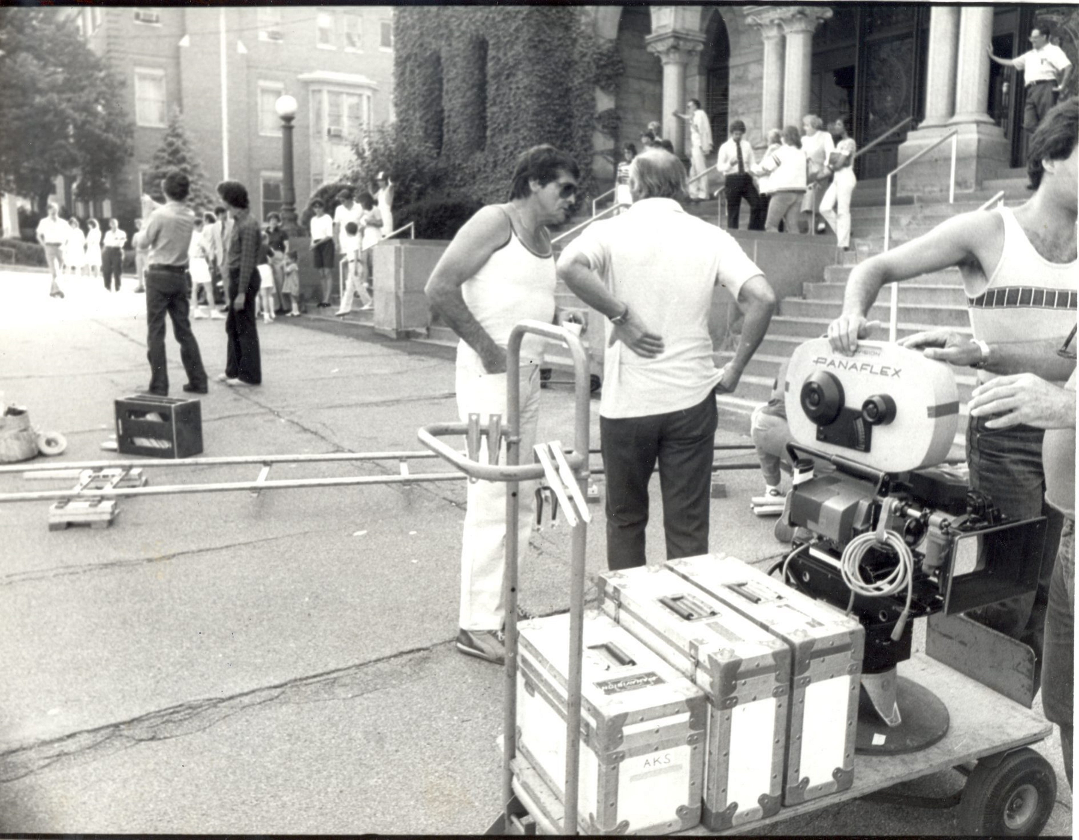 Director Jason Miller, on left, oversees the positioning of equipment...
