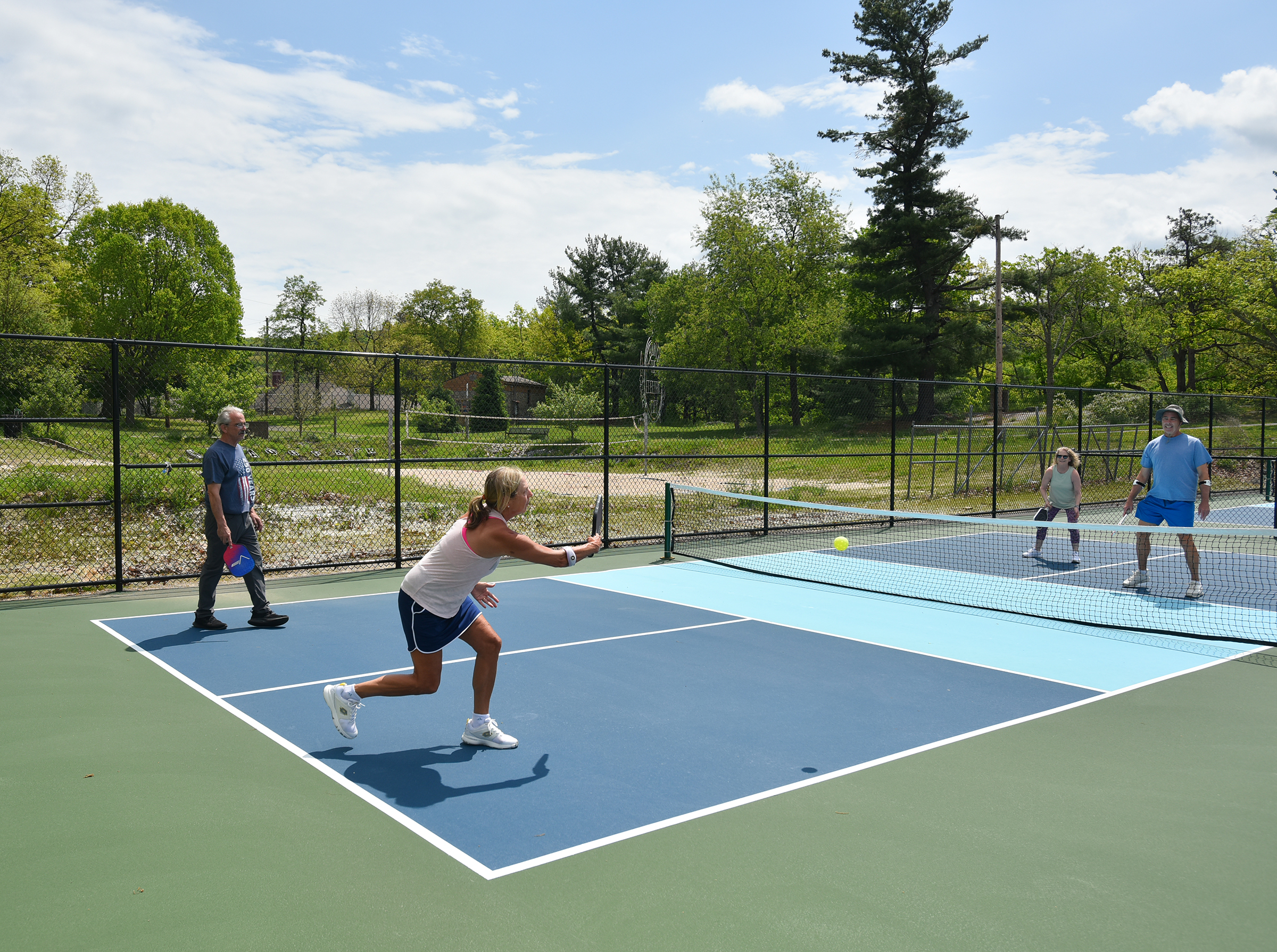 People play pickleball on the new courts at Nay Aug...