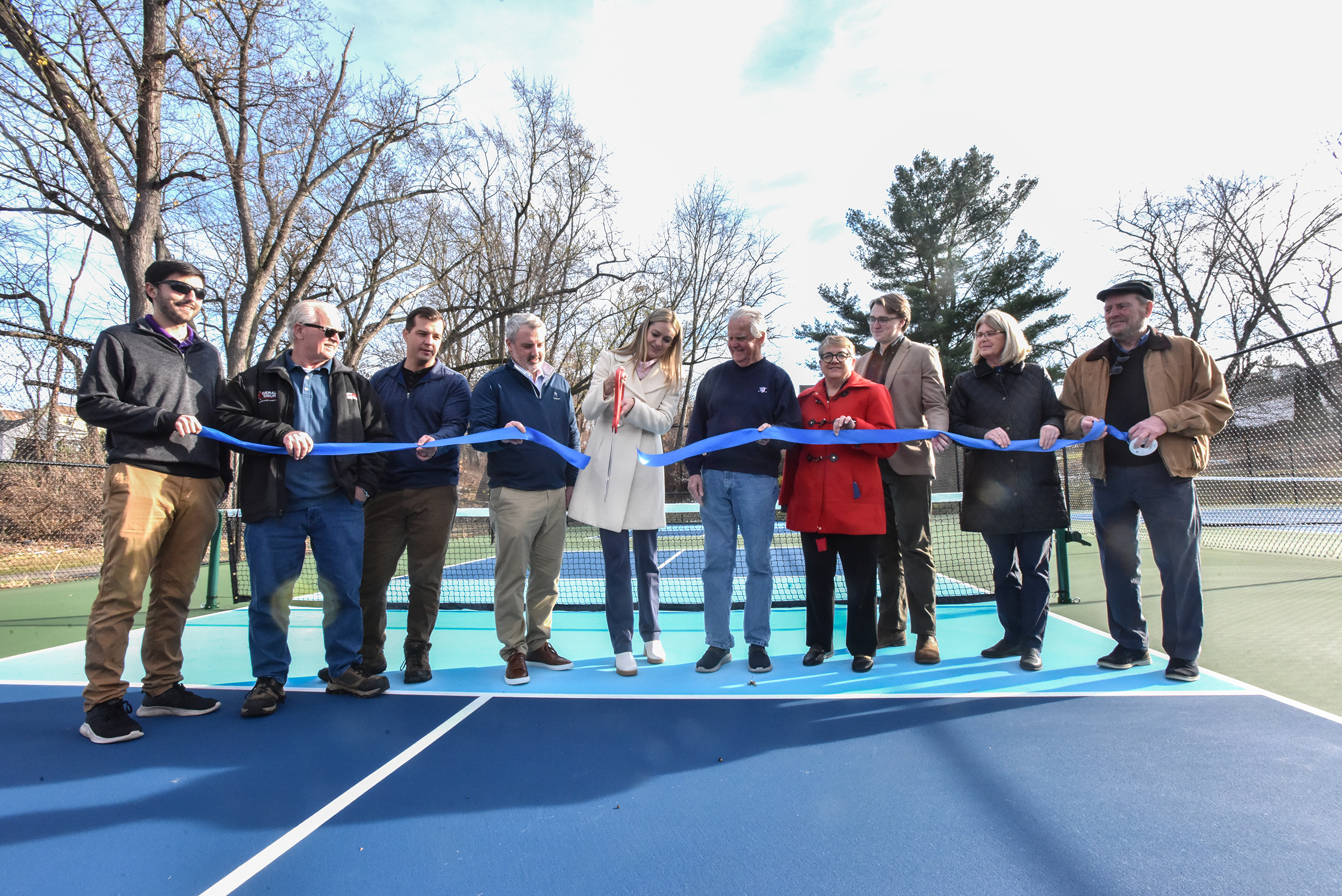 Scranton Mayor Paige Cognetti, center, cuts the ribbon to unveil...