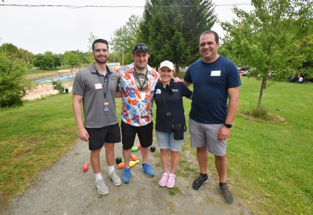 Teachers Matt Gahl, Scott Grecco, Rob Rowinski, and Kathleen O'Donnell, pose for a photograph during the Scranton Cyber School picnic at Nay Aug Park in Scranton Wednesday, May 27, 2026. (SEAN MCKEAG / STAFF PHOTOGRAPHER)