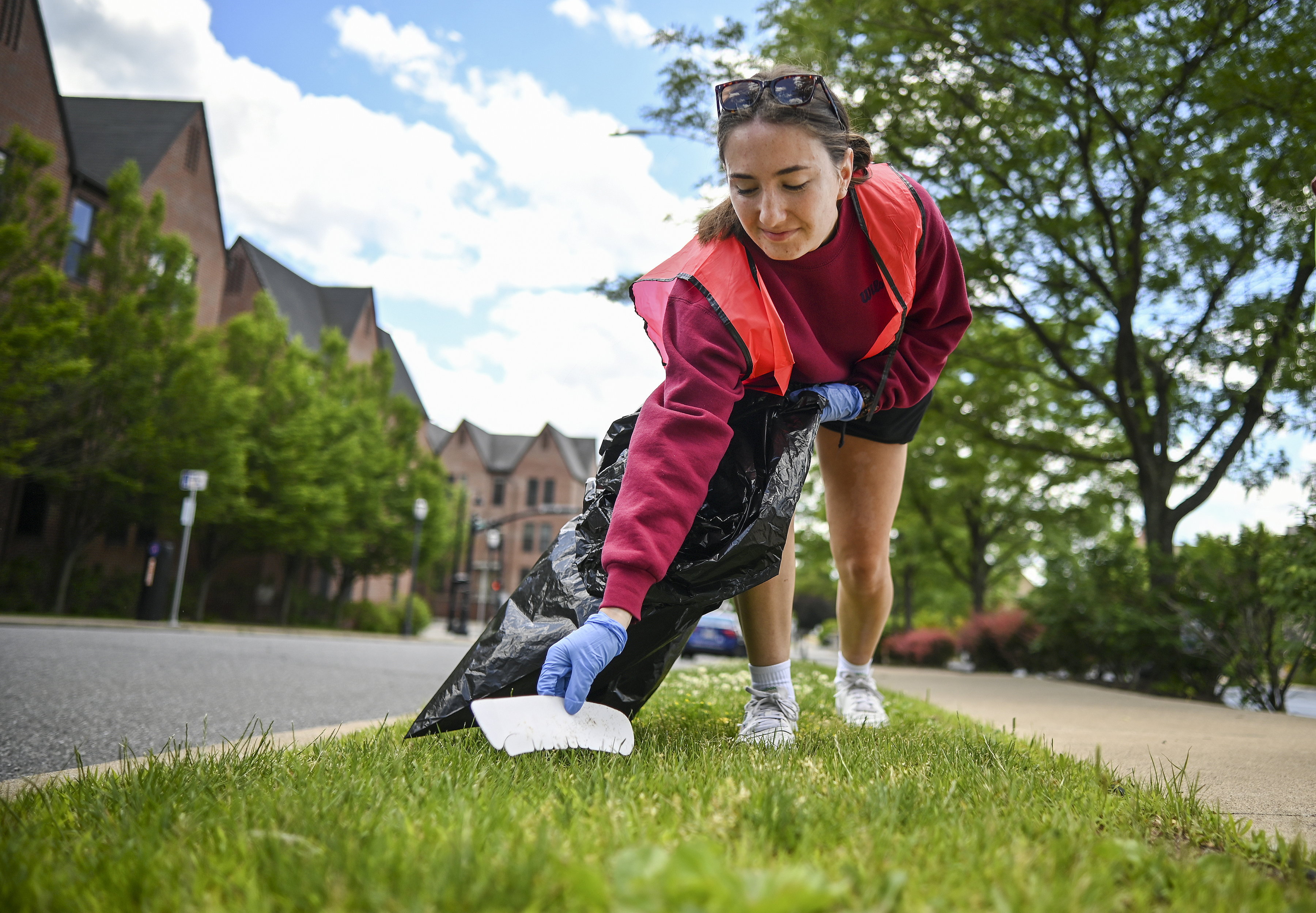University of Scranton’s Stephanie Patullo picks up trash along Madison...