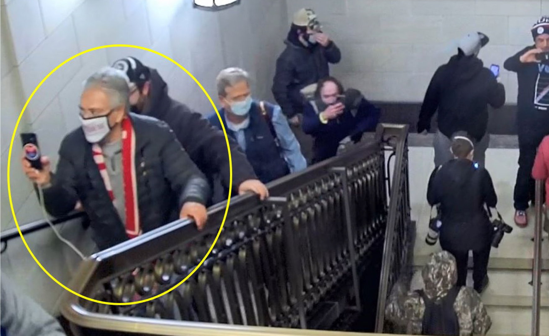 Former Old Forge School Director Frank Scavo, circled, climbs stairs...