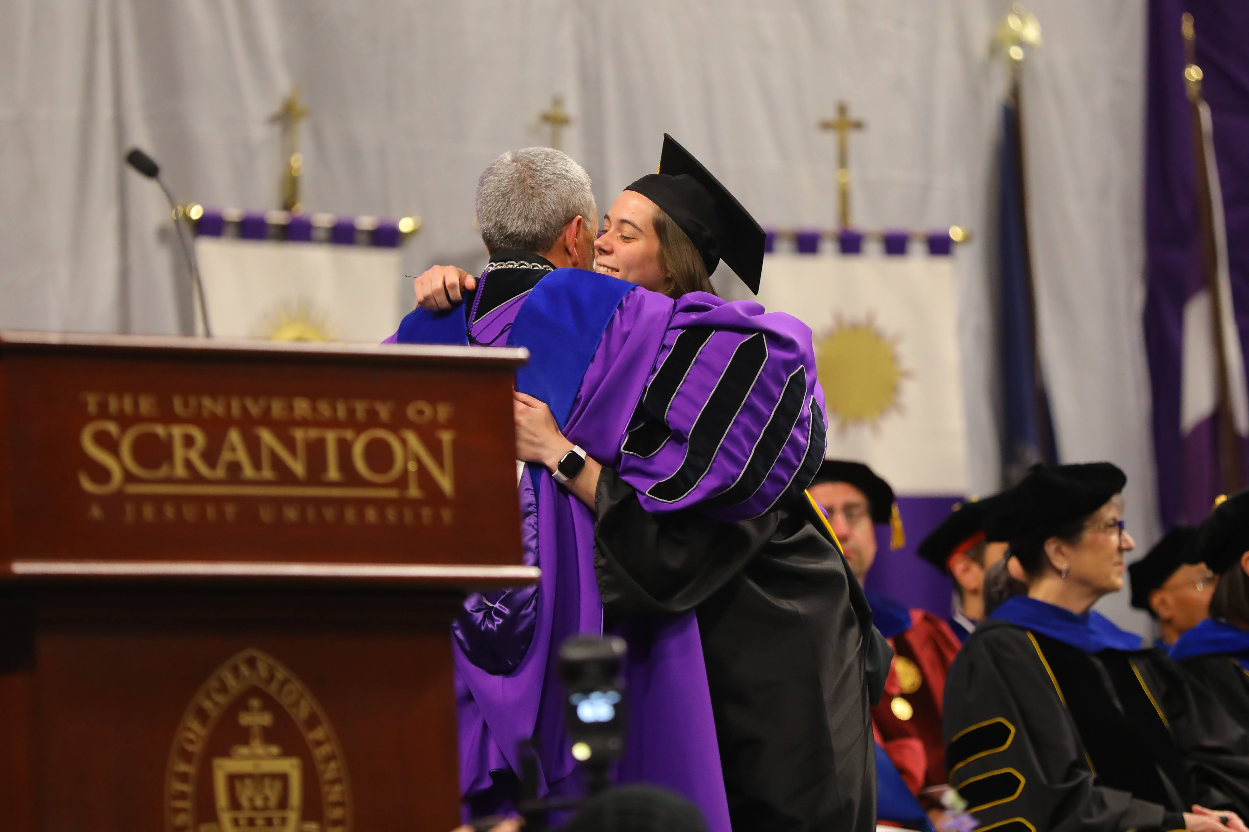 Kaeli Romanowski of Lake Ariel receives her degree Sunday during...