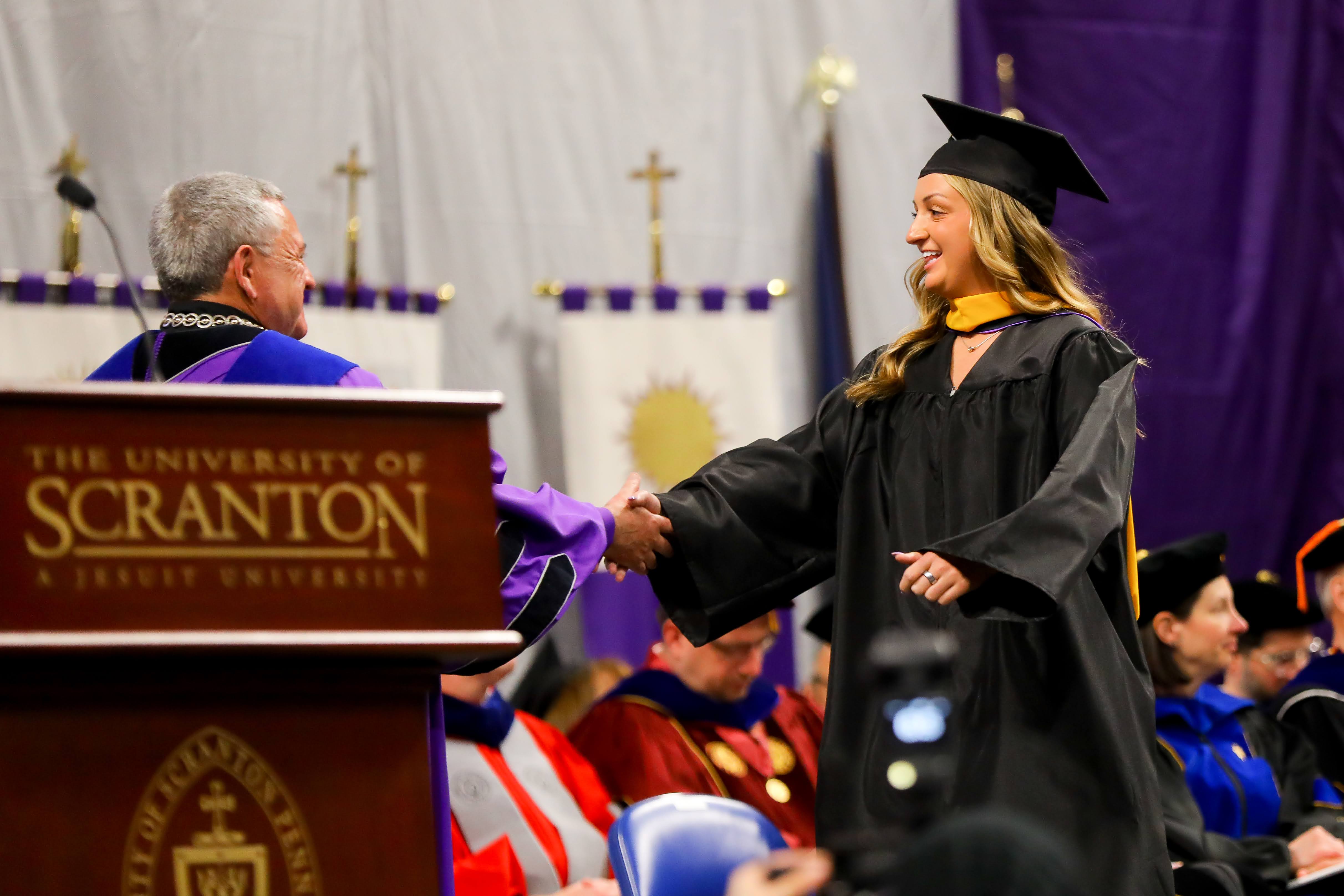 Madison M. Markiewicz of Archbald receives her degree Sunday during...
