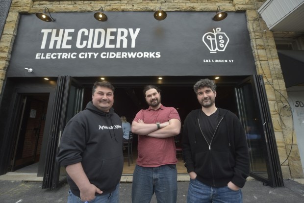 Electric City Ciderworks on Linden Street in Scranton opened in April. Three brothers, Tom, left, Alex, middle, and Mike Borthwick, transformed the downtown property into a new cidery while preserving some of the city's past in the process. (CHAD SEBRING/STAFF PHOTO)