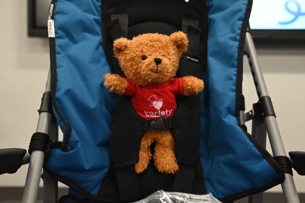 A bear sits in a stroller during the equipment giveaway at Northeastern Educational Intermediate Unit in Archbald on Tuesday, May 5, 2026. Variety The Children's Family gave seven local families adaptive strollers and bikes. (REBECCA PARTICKA/STAFF PHOTOGRAPHER)