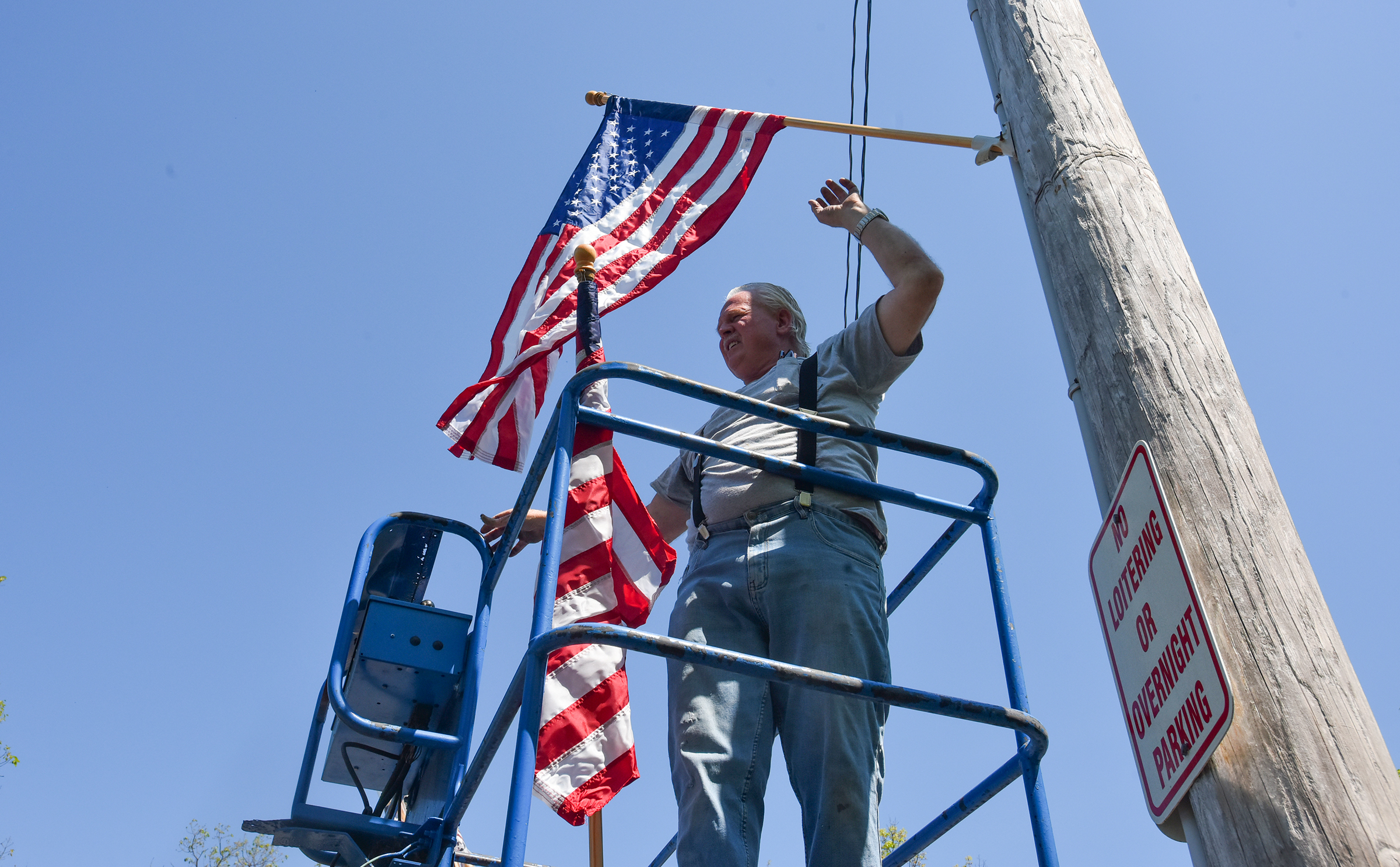 Gerald Smurl, of Scranton, puts up an American flag in...